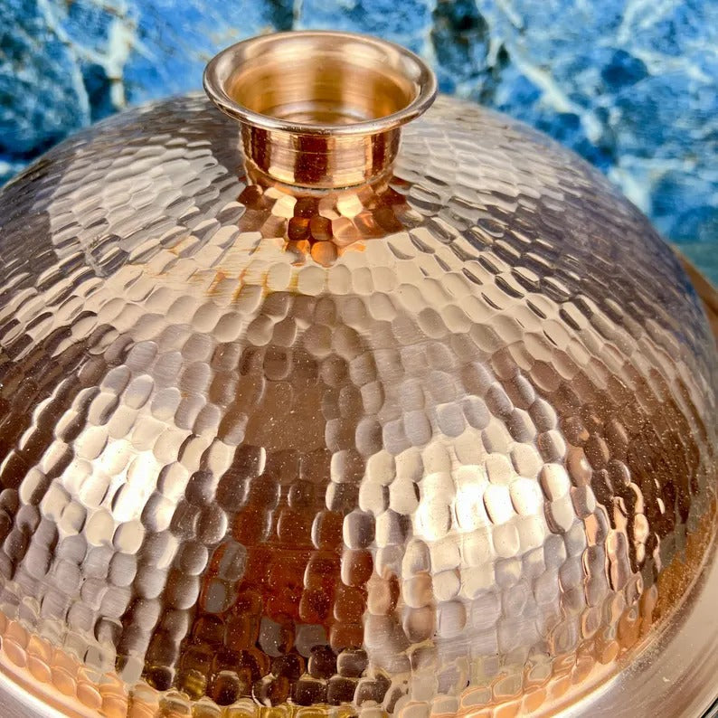 Handmade copper cooking pot lid with a hammered finish, showcasing artisan craftsmanship and quality.
