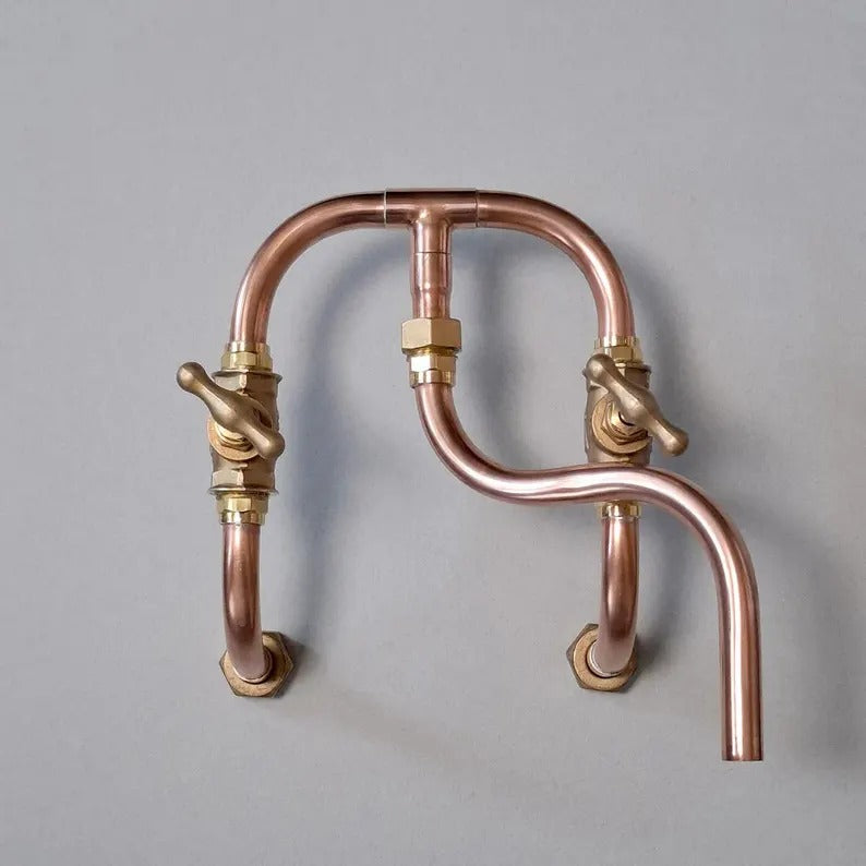 Handmade copper wall mount faucet with solid brass valves for kitchen or bathroom decor.
