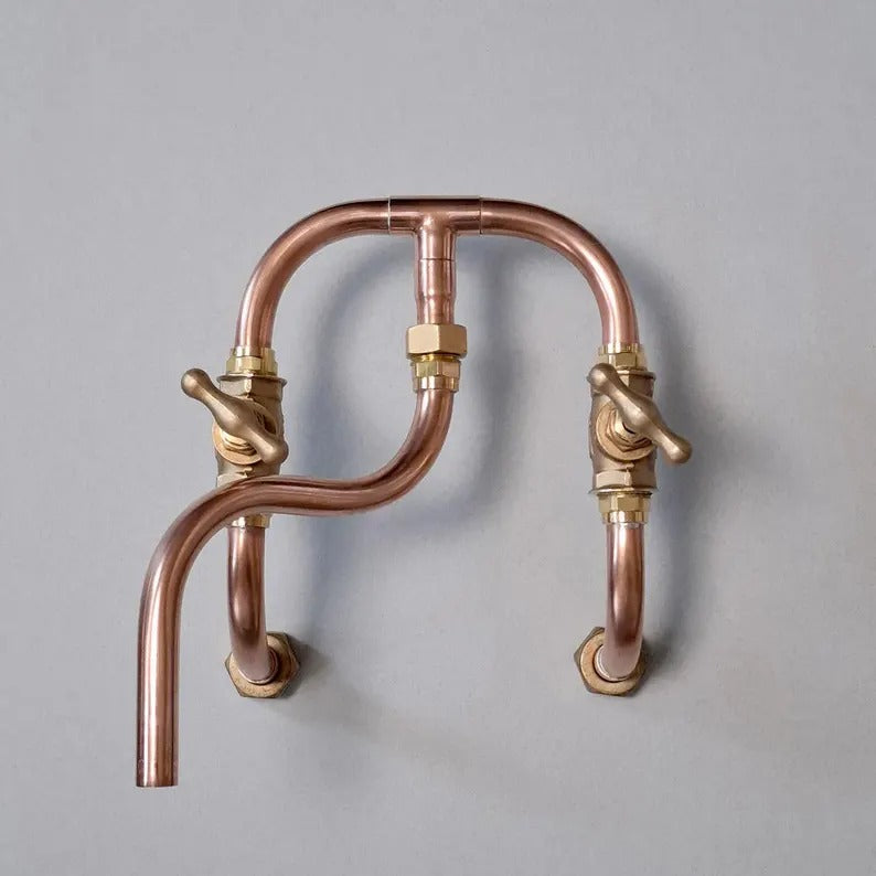 Handmade copper wall mount faucet with solid brass valves for kitchen and bathroom décor.
