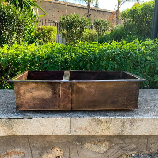 Cooper handmade undermount double vessel sink made of copper, showcasing beautiful craftsmanship for kitchen decor.