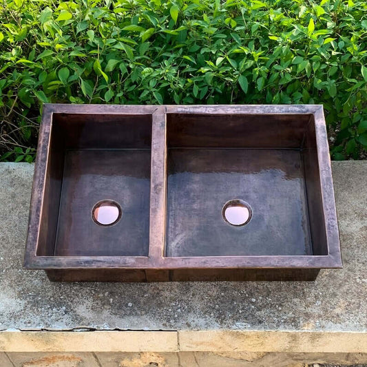 Cooper handmade double vessel sink in copper for kitchen decor, showcasing elegant design and craftsmanship.