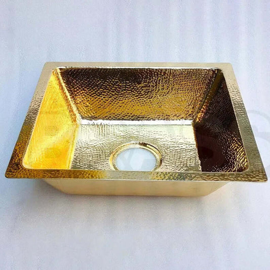 Elegant handcrafted brass bar sink with hammered finish, perfect for kitchen or wet bar use.