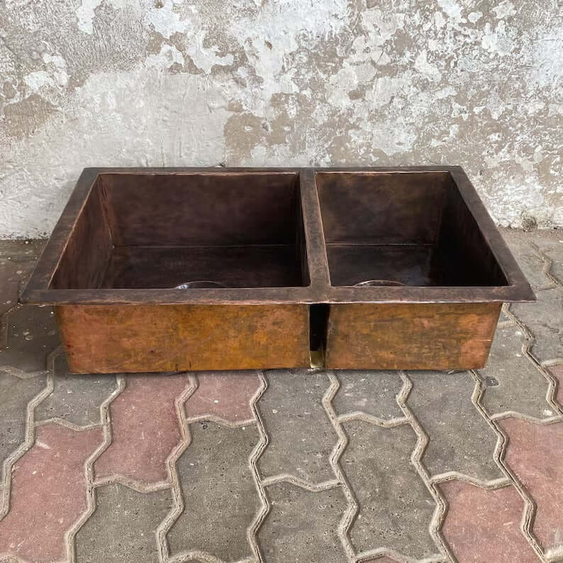Handmade double vessel sink made of copper, perfect for bathroom or kitchen decor.