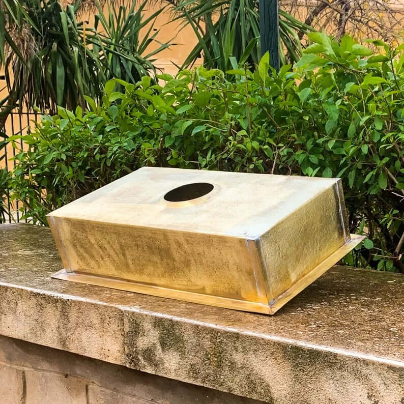 Golden brass sink designed for bathrooms, showcasing artisanal craftsmanship and natural finishes.