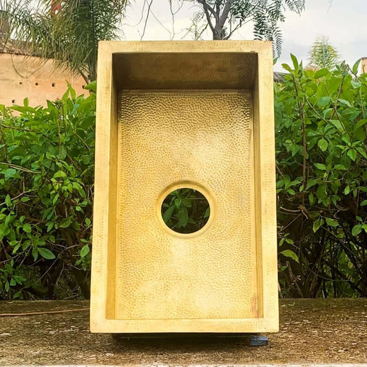 Handmade Moroccan brass sink with textured surface and circular cutout, perfect for bathroom use.