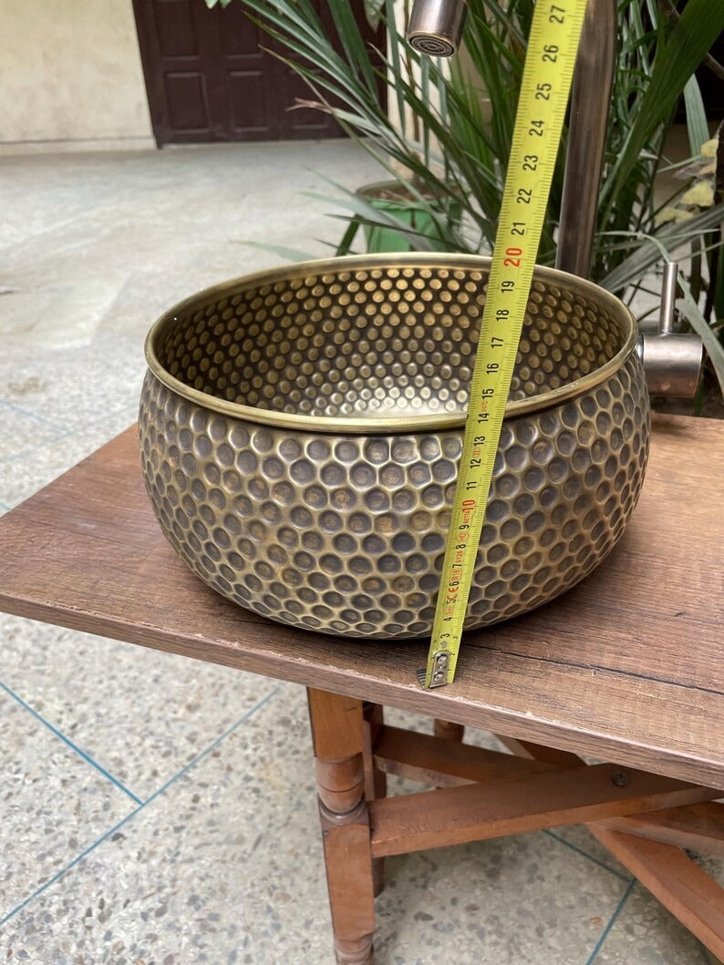 Hand hammered brass kitchen sink with honeycomb texture, showcasing Moroccan elegance for a unique kitchen design.