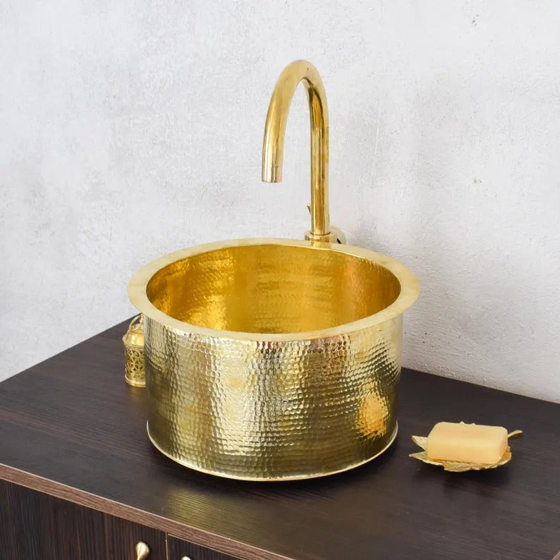 Handmade brass sink with a hammered finish, perfect for bathroom design and decor.
