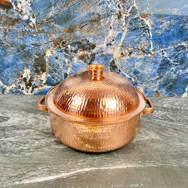 Handmade copper cooking pot with hammered finish on marble background, perfect for elegant Moroccan kitchenware.