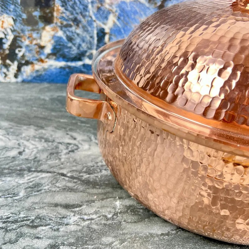 Handmade copper cooking pot with hammered finish, showcasing artisan Moroccan kitchenware elegance.