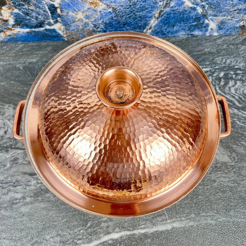 Handmade copper cooking pot with a hammered finish, perfect for artisan Moroccan kitchenware.