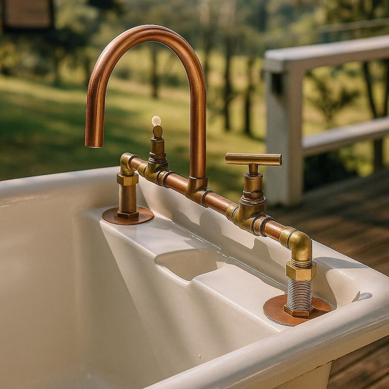 Handmade copper and brass faucet mixer tap installed on a vintage bathtub outdoors, showcasing rustic design.