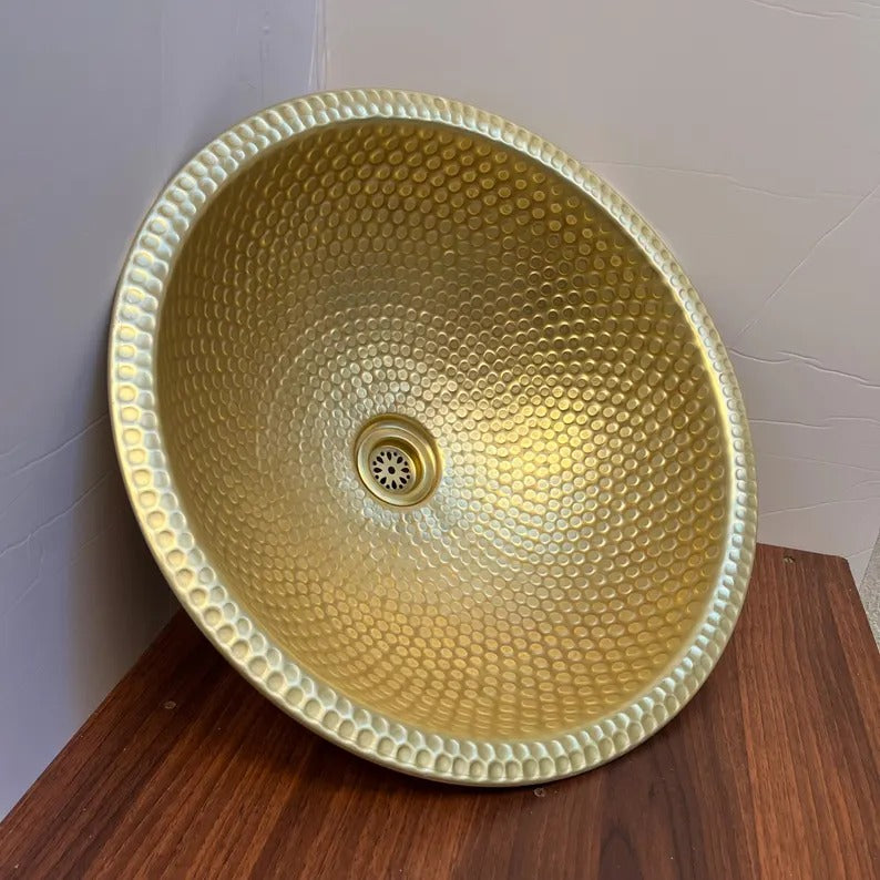 Handmade brass vessel sink with a hammered texture, perfect for elevating bathroom decor.