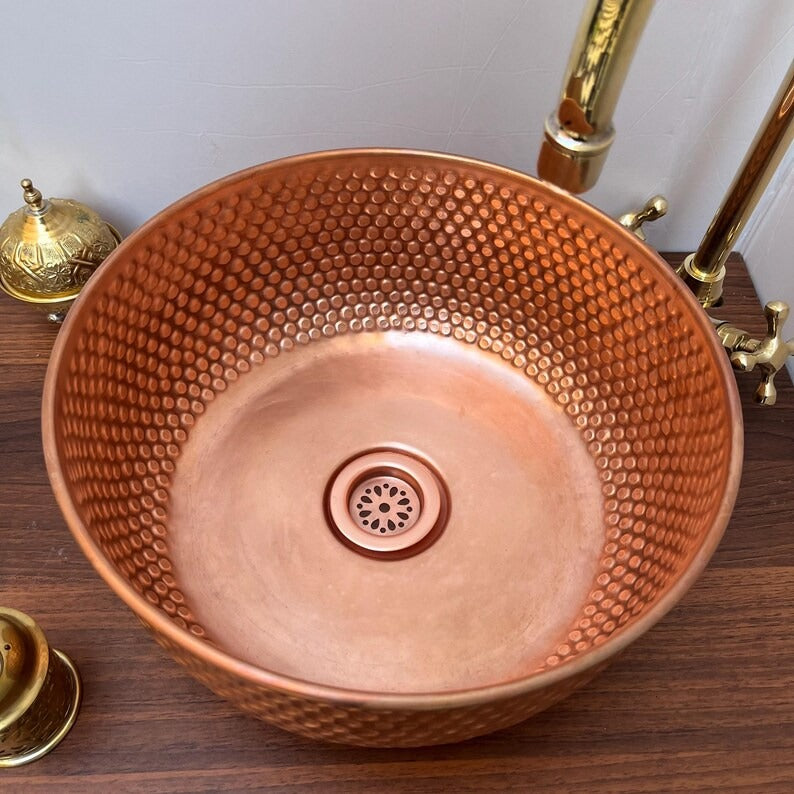Brushed copper bathroom sink with hammered finish, ideal for modern countertop vessel basin.