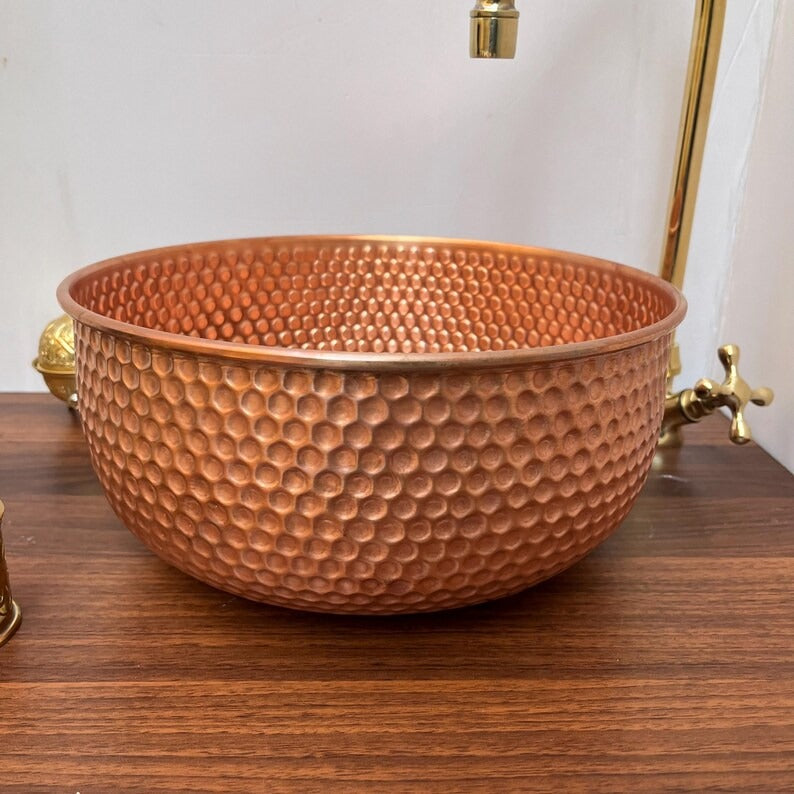 Handcrafted brushed copper vessel sink featuring a unique hammered design, perfect for modern bathrooms or kitchens.