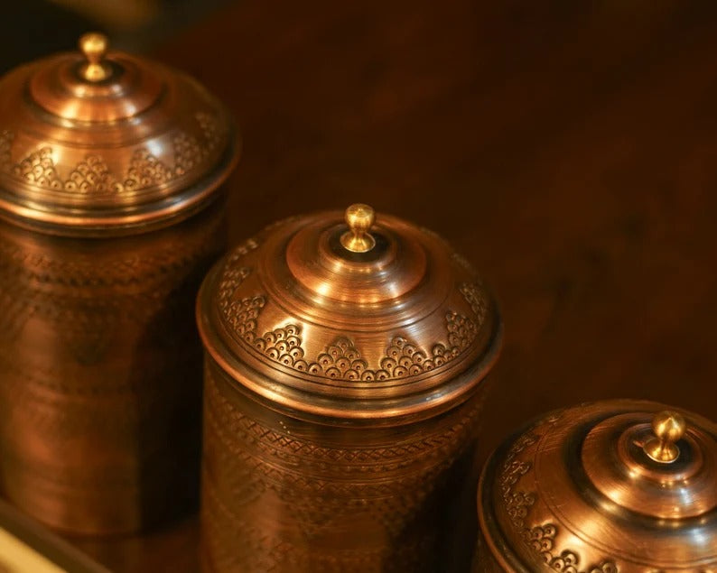 Handmade copper spice containers, set of 3, featuring intricate designs and elegant lids, perfect for kitchen decor.