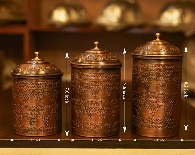 Set of 3 handmade copper spice containers with decorative lids, measuring 4.3, 7.0, and 8.2 inches tall.