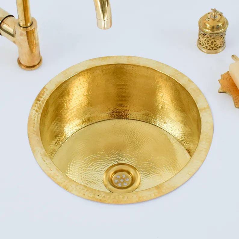 Handmade brass sink with a hammered finish, showcasing its antique charm for a stylish bathroom.